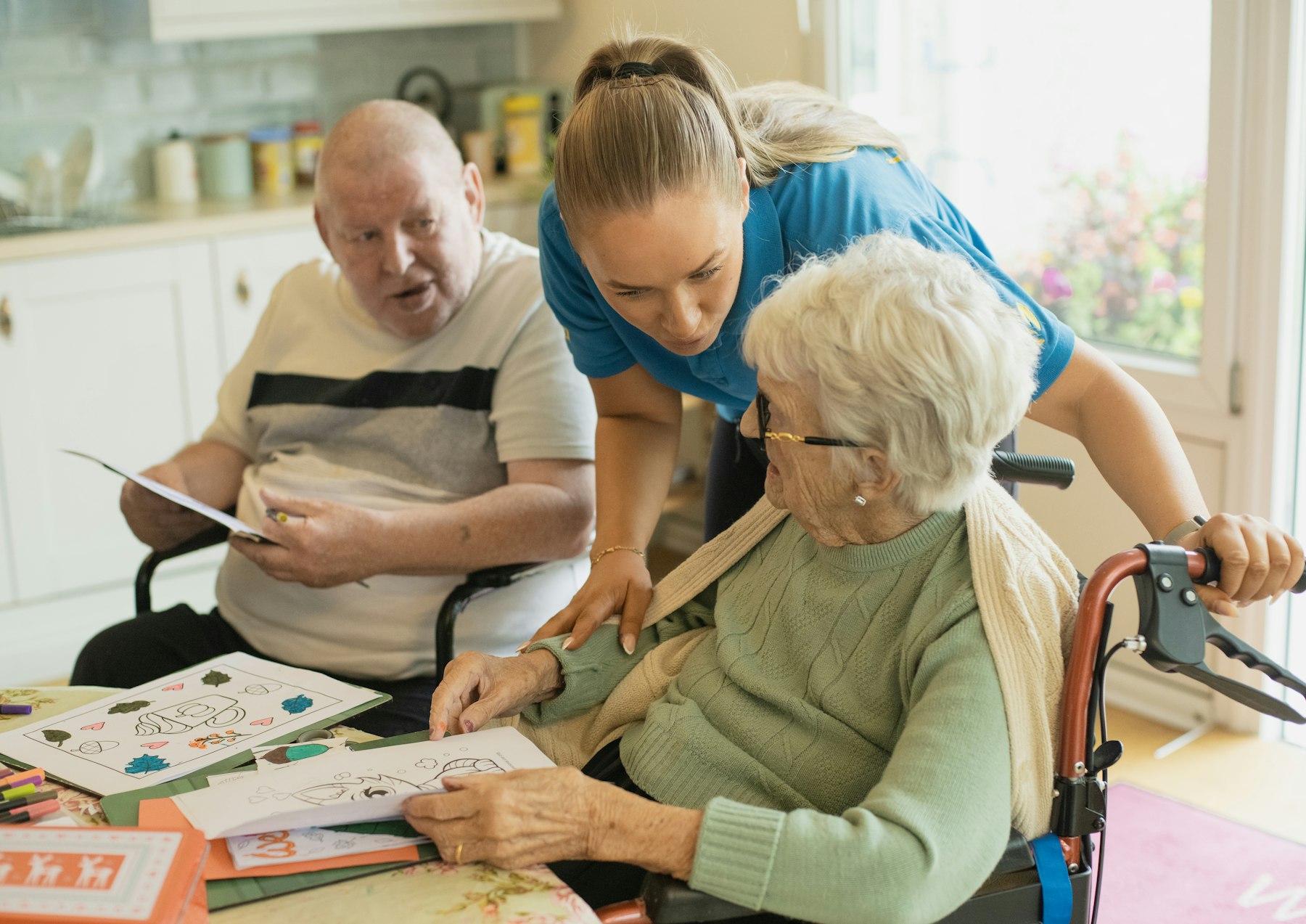 Caregiver assisting residents with an activity